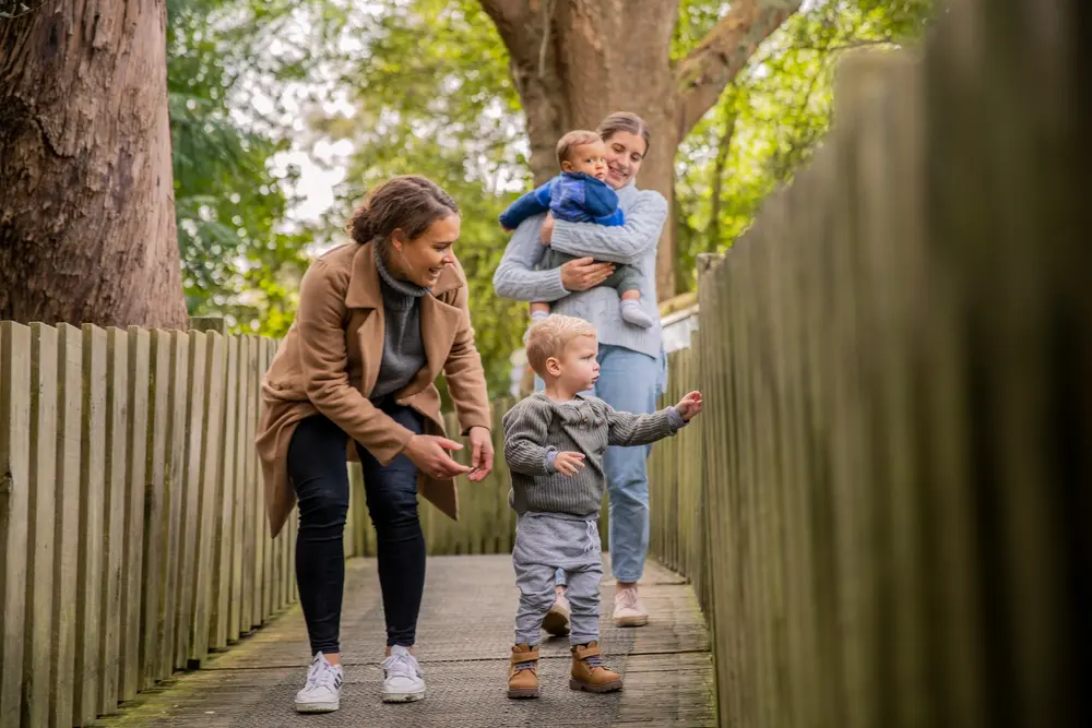 A young family crossing a bridge at Hamilton Zoo