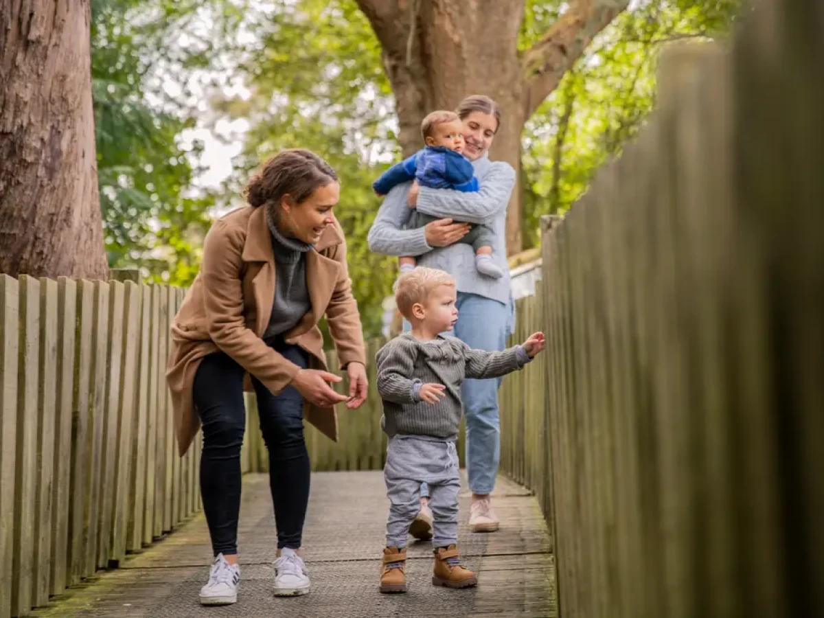 A young family crossing a bridge at Hamilton Zoo