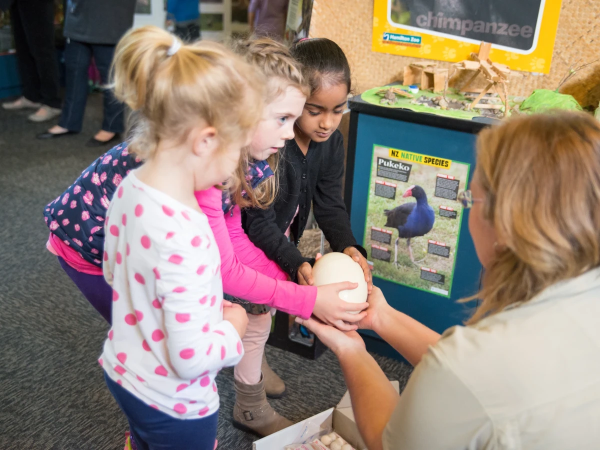 Young children talking to a zoo educator