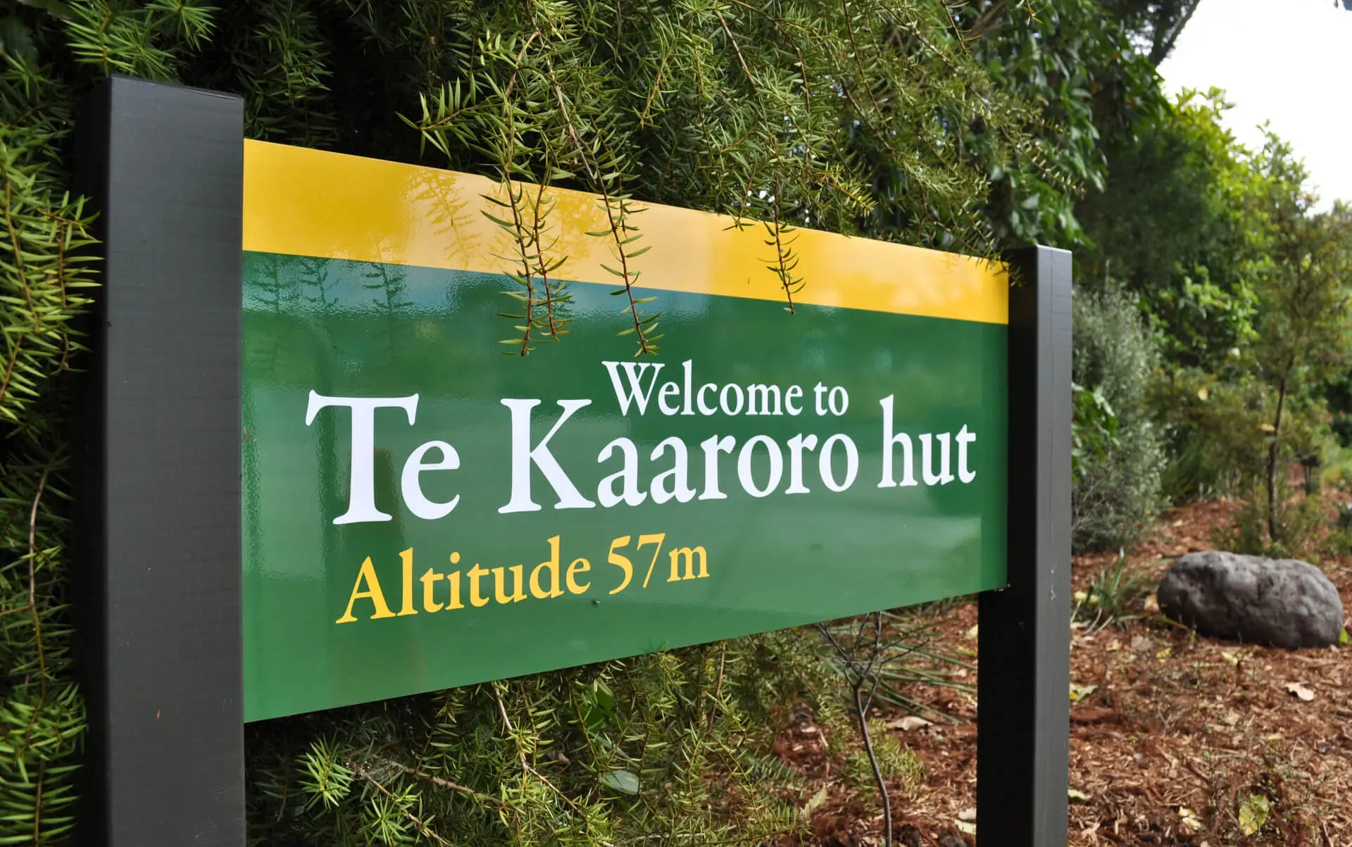 A sign stating welcome to Te Kaaroro hut in the same style as Department of Conservation signage