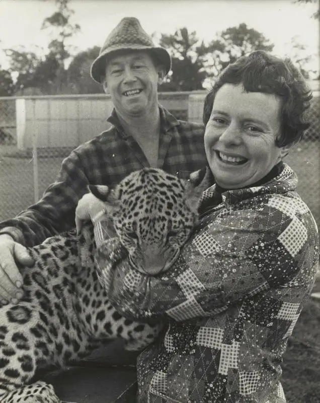 A man and a woman holding a jaguar